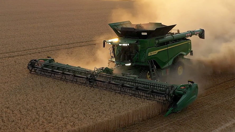 John Deere X9 Combine Harvester Working in a Golden Wheat Field at Sunset HD wallpaper