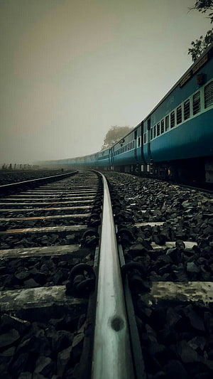 Moody Indian Railway Train on Foggy Tracks with Blue Carriages HD phone wallpaper