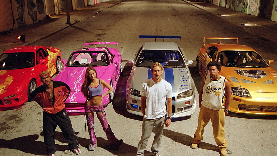 2 Fast 2 Furious Cast with Modified Supras and Mustangs in Night Street Scene HD wallpaper
