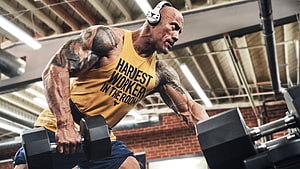Dwayne Johnson Performing Dumbbell Row in Gym Wearing Yellow Tank Top HD wallpaper