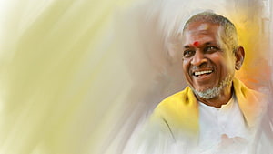 Ilaiyaraaja Portrait in Yellow Shawl with Warm Golden Background HD wallpaper