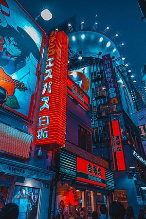 Neon-lit Tokyo street at night with glowing red and blue signs and anime billboard HD phone wallpaper