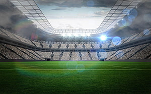 Vast Football Stadium Interior With Floodlights And Green Pitch HD wallpaper