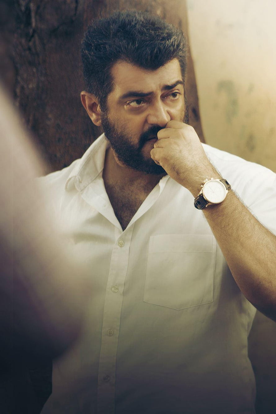 Ajith Kumar in a white shirt with a contemplative expression and wristwatch HD phone wallpaper