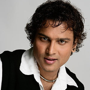 Zubeen Garg Portrait with Curly Hair and Black Vest HD phone wallpaper