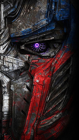 Optimus Prime Close-Up Portrait with Glowing Purple Eye and Weathered Red Armor HD phone wallpaper