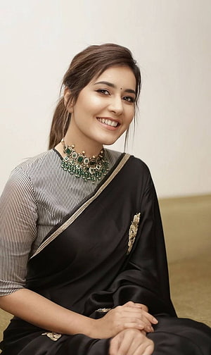 Rashi Khanna in an elegant black saree with gold border and emerald green jewelry HD phone wallpaper