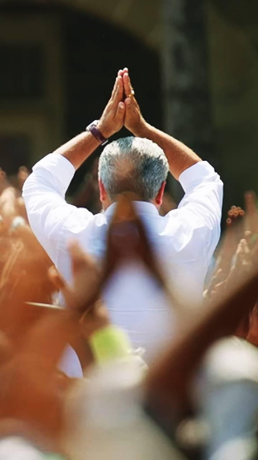 Ajith in White Shirt with Hands Folded in Prayer Before a Crowd HD phone wallpaper