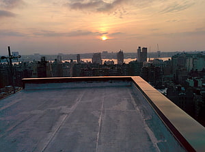 City Skyline at Sunset Viewed from a Rooftop Terrace HD wallpaper