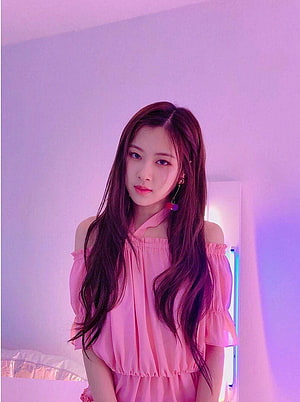 Rose from BLACKPINK in a soft pink off-shoulder blouse with long wavy hair under pastel purple lighting HD phone wallpaper