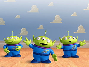 Three Toy Story Little Green Men Aliens in Blue Space Suits on a Wooden Floor HD wallpaper