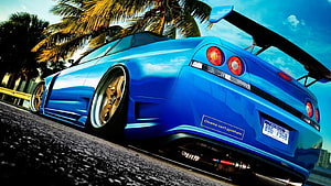 Blue Nissan Skyline GT-R R34 Stance Build With Gold Wheels and Large Rear Wing HD wallpaper