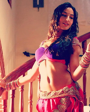 Nora Fatehi in Vibrant Traditional Attire on Wooden Staircase HD phone wallpaper