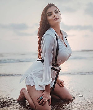 Anveshi Jain Kneeling on Beach in White Shirt and Leather Harness HD phone wallpaper