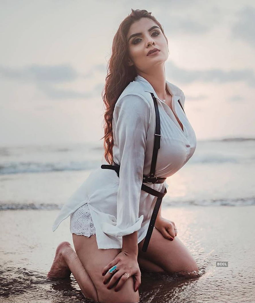 Anveshi Jain Kneeling on Beach in White Shirt and Leather Harness HD phone wallpaper