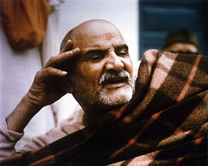 Neem Karoli Baba Portrait with Plaid Shawl and Hand Gesture HD wallpaper