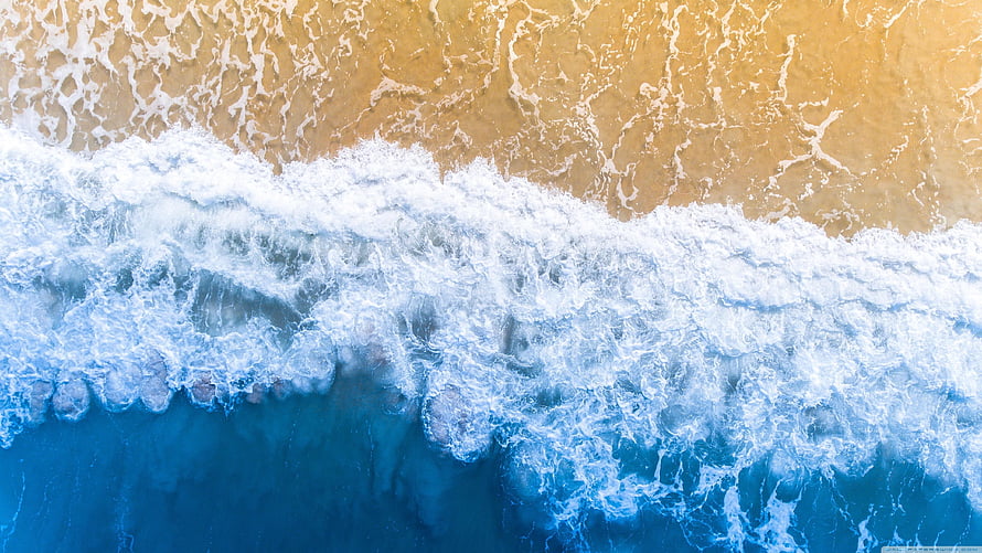 Aerial View of Turquoise Ocean Waves Crashing on Golden Sand Beach HD wallpaper