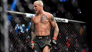 Charles Oliveira in the UFC Octagon with chest tattoo and fighting gloves HD wallpaper