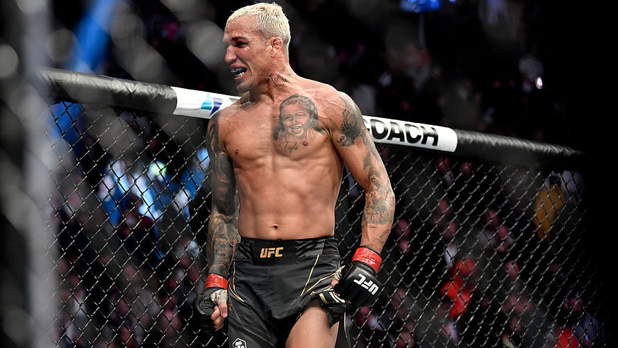Charles Oliveira in the UFC Octagon with chest tattoo and fighting gloves HD wallpaper