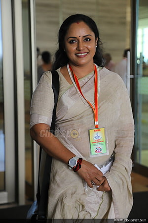 Nisha Sarang in a beige saree with pearl necklace and event lanyard at a public appearance HD phone wallpaper