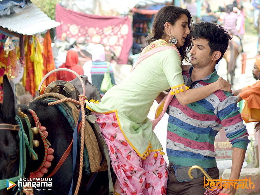 Kedarnath Movie Still: Sushant Singh Rajput and Sonam Kapoor in Vibrant Indian Market Scene HD wallpaper