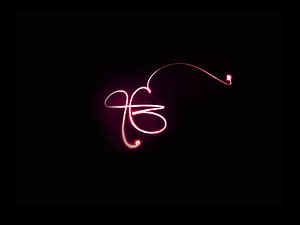 Glowing Pink Neon Ek Onkar Symbol on Black Background HD wallpaper