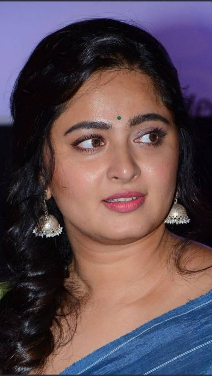 Anushka Shetty in a blue saree with traditional jhumka earrings and a green bindi HD phone wallpaper