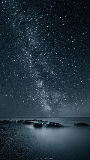 Milky Way Galaxy Over a Dark Ocean Beach at Night with a Shooting Star HD phone wallpaper