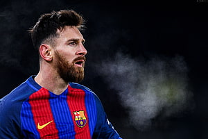 Lionel Messi in FC Barcelona Home Kit with Dramatic Dark Background and Smoke HD wallpaper