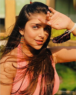 Ishita Chauhan in a pink top with colorful beaded earrings and long dark hair HD phone wallpaper