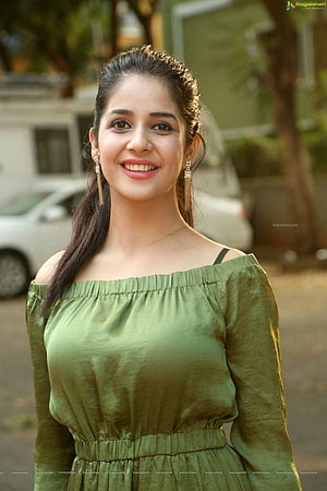 Smiling woman in an olive green off-shoulder dress with long dark hair and dangling earrings, Top 100 Hottest Desi Girls of Pakistani Indian Girls, most cute indian girl HD phone wallpaper