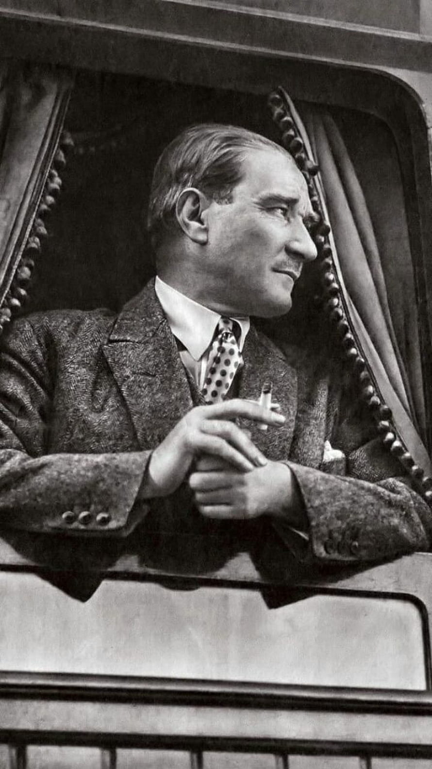 Mustafa Kemal Ataturk in a tweed suit holding a cigarette in a vintage black and white portrait HD phone wallpaper