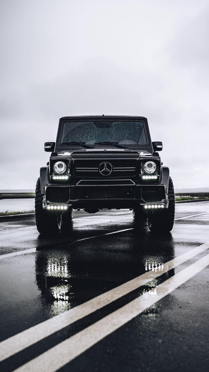 Black Mercedes G-Class SUV Front View on Wet Asphalt Road with LED Lights and Reflections HD phone wallpaper
