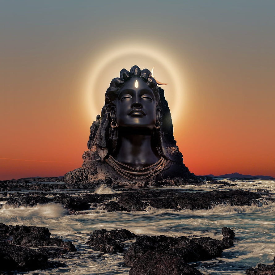 Lord Shiva Statue with Glowing Halo at Sunset on Rocky Coastline HD phone wallpaper