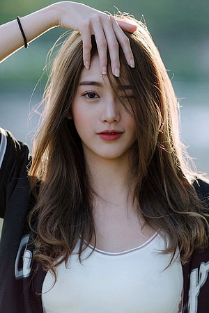 Young Asian Woman With Long Wavy Hair Winking Outdoors In Soft Natural Light, Young Girl posted by Samantha Simpson, stylish chinese cute girl HD phone wallpaper