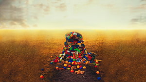 Colorful Toy Tower in Golden Wheat Field at Sunset HD wallpaper