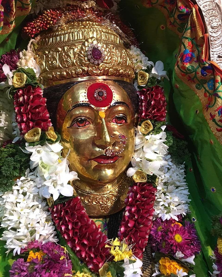 Golden Murti of Goddess Ekvira Adorned with Floral Garlands and Traditional Crown HD phone wallpaper