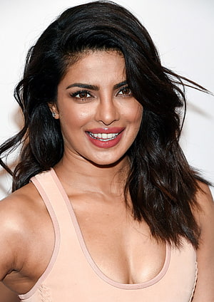 Priyanka Chopra smiling portrait with dark wavy hair and soft pink top HD phone wallpaper