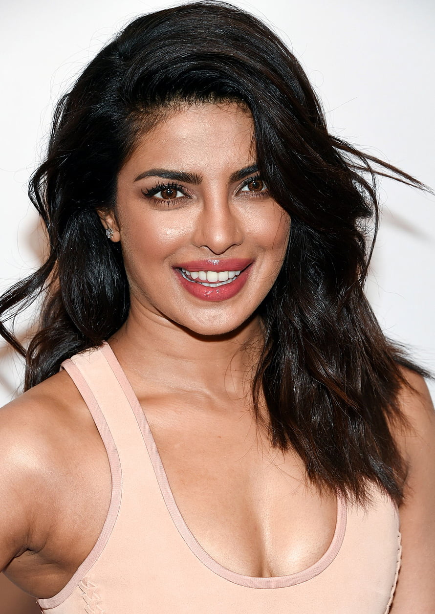 Priyanka Chopra smiling portrait with dark wavy hair and soft pink top HD phone wallpaper