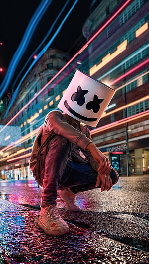 Anonymous Hacker in White Mask Crouching on Neon-Lit City Street at Night HD phone wallpaper