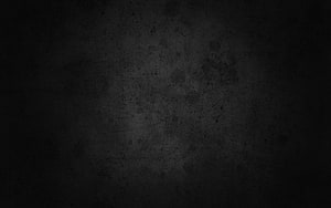 Dark Grunge Texture with Subtle Scratches and Speckles on a Black Surface HD wallpaper