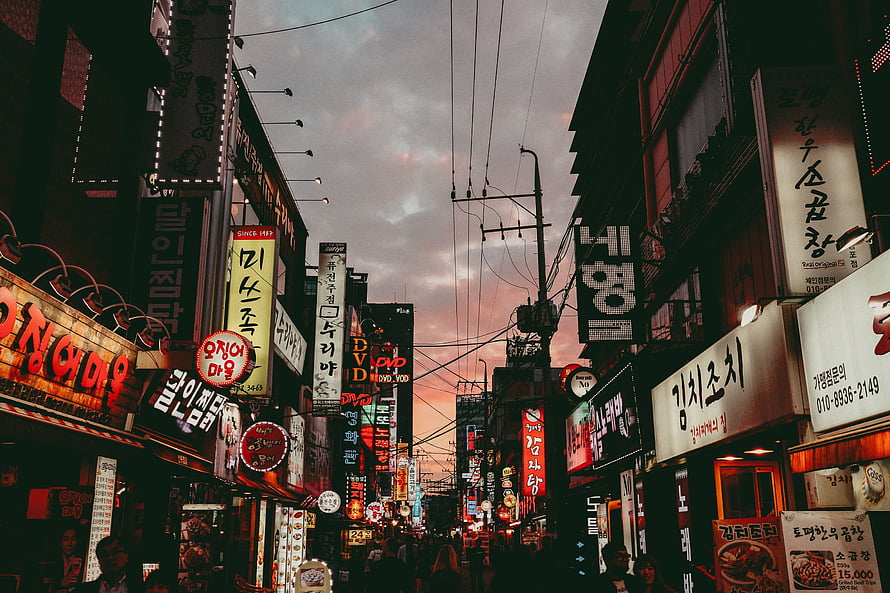Vibrant Korean Street Scene at Dusk with Neon Signs and Crowded Market HD wallpaper