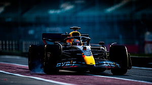 Red Bull Racing Formula 1 car speeding on the track with tire smoke HD wallpaper
