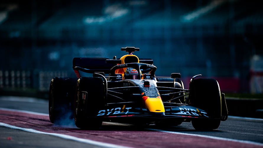 Red Bull Racing Formula 1 car speeding on the track with tire smoke HD wallpaper