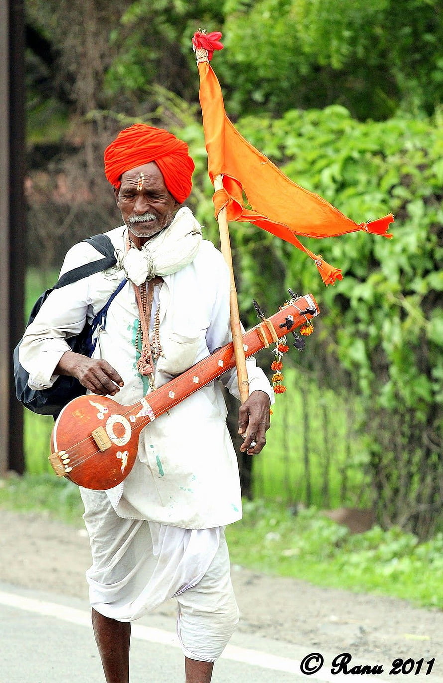 Varkari Devotee Carrying Traditional Tanpura and Orange Flag in White Attire HD phone wallpaper