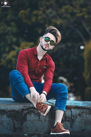 Stylish Young Man in Red Shirt and Sunglasses Sitting on Stone Wall HD phone wallpaper