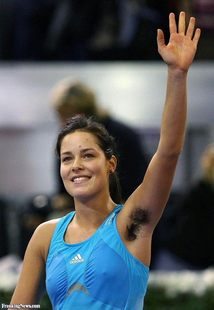 Female athlete in blue Adidas tank top waving to the crowd at a sporting event HD phone wallpaper