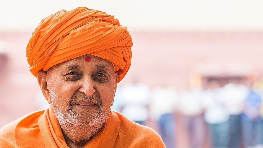 Portrait of Pramukh Swami Maharaj in Traditional Orange Saffron Attire HD wallpaper