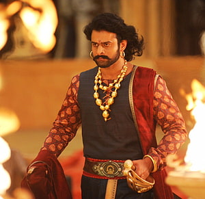 Prabhas as Baahubali in ornate royal costume with gold jewelry and ceremonial regalia HD wallpaper