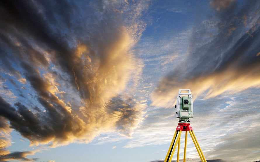 Total Station Surveying Instrument on Tripod Against Dramatic Sunset Sky HD wallpaper
